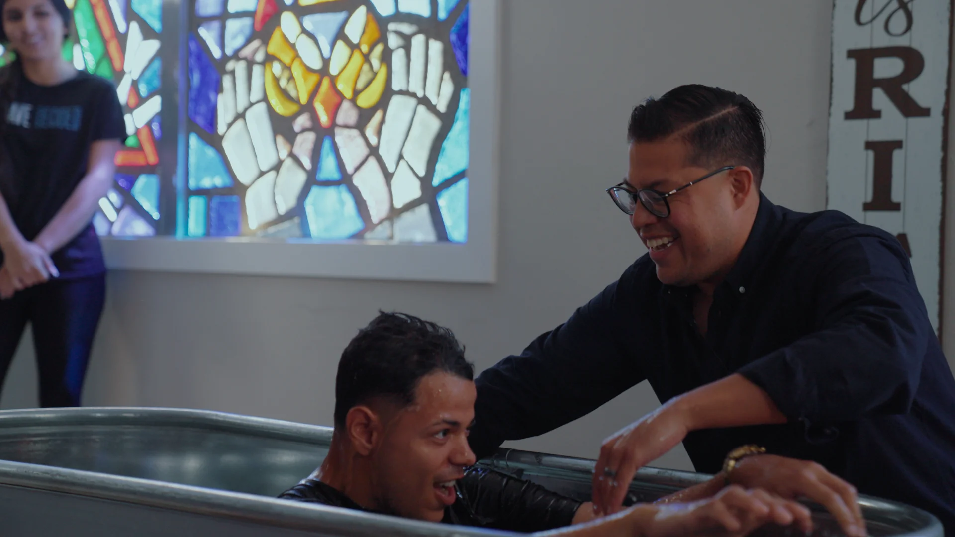 A man being baptized inside a church.